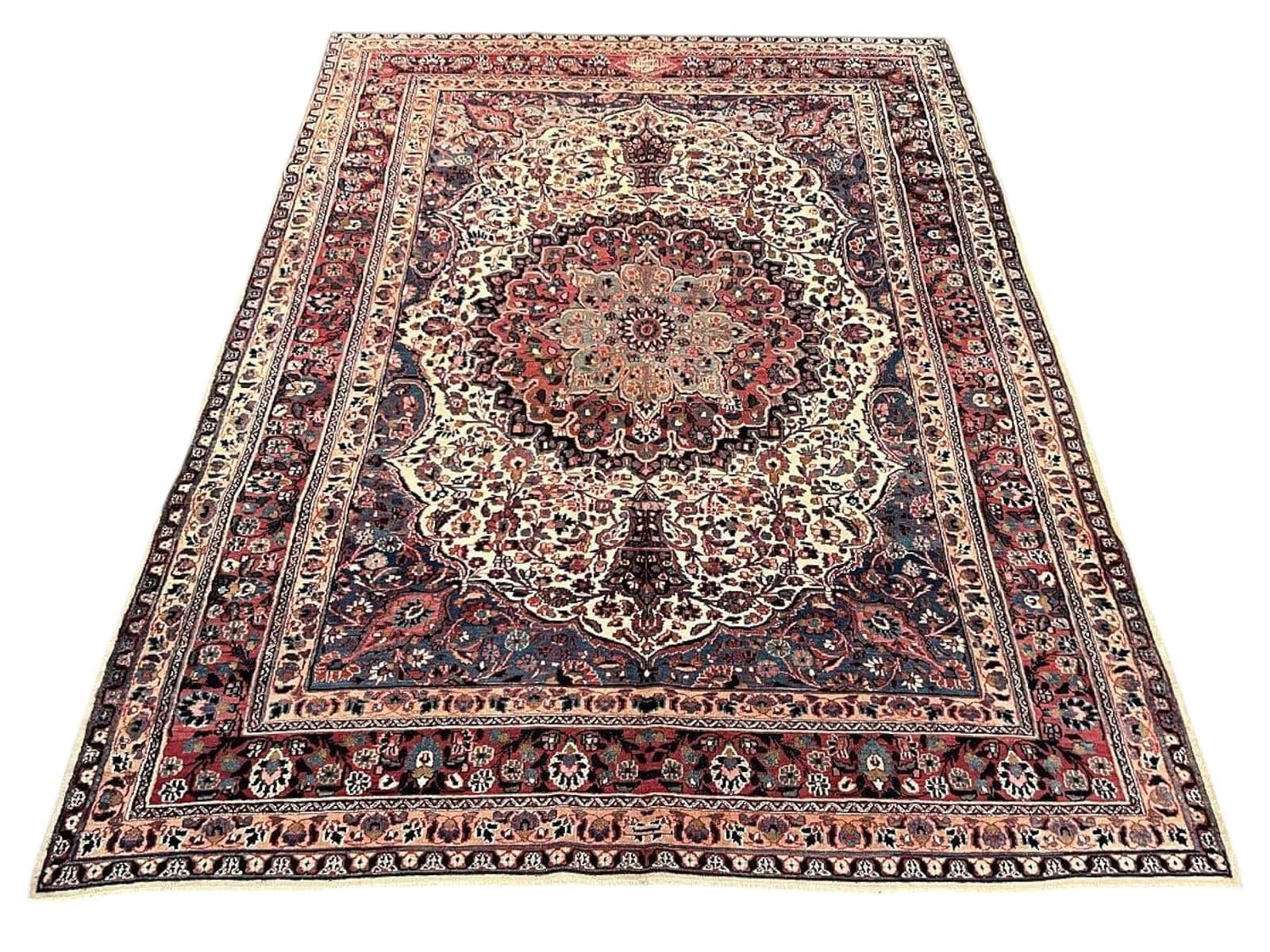 Patterned Persian Mashhad rug from a recent Prime auction catalog
